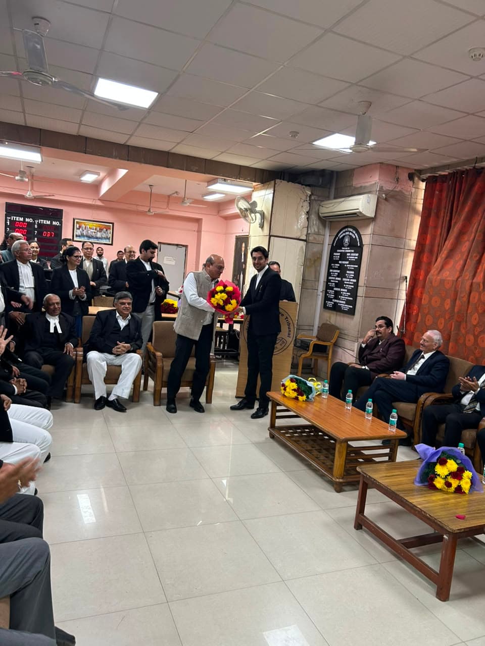 Jatin Parashar receiving a bouquet at a tribunal bar association event